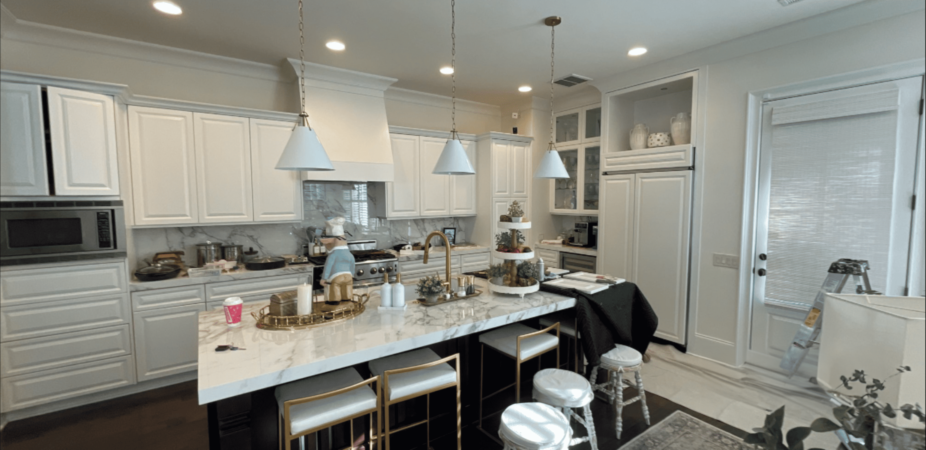a kitchen with marble countertop and white cabinets- charlotte nc cabinet painters